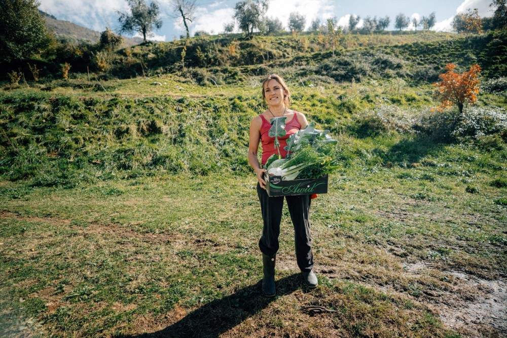 female farmer carrying vegetables